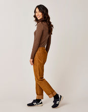 Side view of a Woman wearing the Brown corduroy Carson Cord pants, Carve Designs