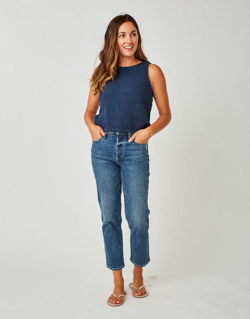 Front view of woman wearing a blue tank top shirt and the blue Brady Straight Leg, Carve Designs
