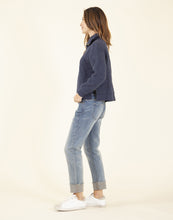 Side view of a woman wearing a blue sweater and the light blue Carson Jeans, Crave Designs