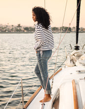 Woman on Boat wearing a black and white stripped sweater and the light blue Carson Jeans, Crave Designs